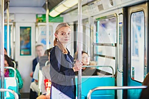 Beautiful young woman travelling in a train of Parisian subway