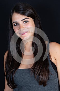 Beautiful young woman under black background