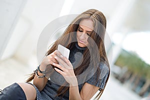 Beautiful young woman in urban background talking on phone photo