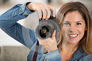 beautiful young woman using camera