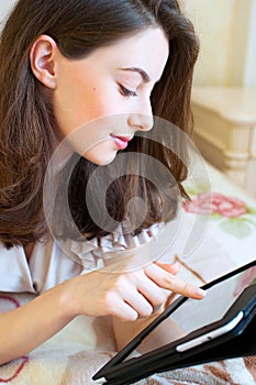 Beautiful young woman using digital tablet computer