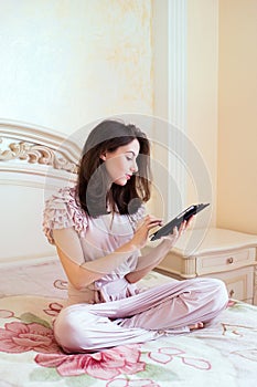 Beautiful young woman using digital tablet computer