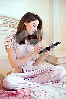 Beautiful young woman using digital tablet computer