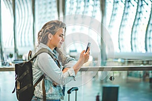 A beautiful young woman using mobile phone at airport