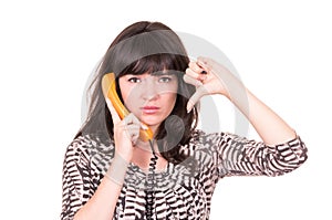 Beautiful young woman using retro orange telephone