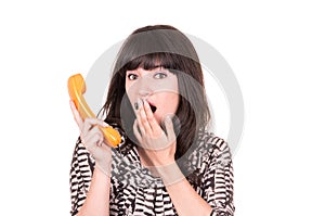 Beautiful young woman using retro orange telephone