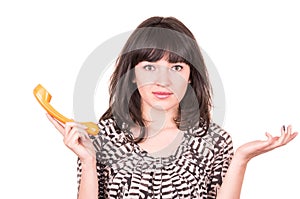 Beautiful young woman using retro orange telephone