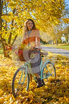 Beautiful young woman on a vintage bike