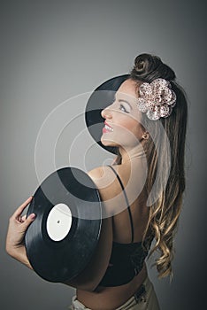 Beautiful young woman with vinyl records