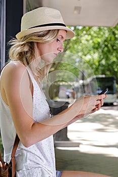 Beautiful young woman waiting for bus