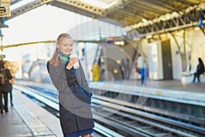 Beautiful young woman waiting for a train in Parisian underground