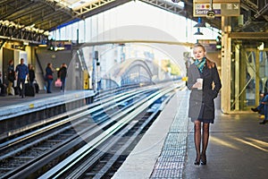 Beautiful young woman waiting for a train in Parisian underground