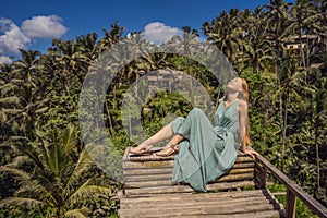 Beautiful young woman walk at typical Asian hillside with rice farming, mountain shape green cascade rice field terraces