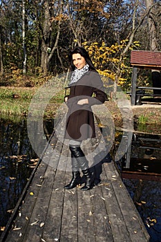 Beautiful young woman walking in autumn park