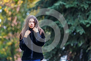 Beautiful young woman walking in autumn park. Autumn fashin concept.