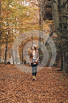 Beautiful young woman walking charming autumn forest