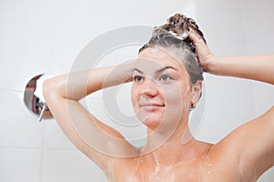 Beautiful young woman washing hair