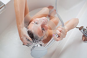 Beautiful young woman washing hair