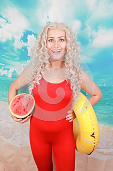 Beautiful young woman with watermelon for eating in summer season at beautiful beach