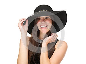 Beautiful young woman wearing black hat and laughing