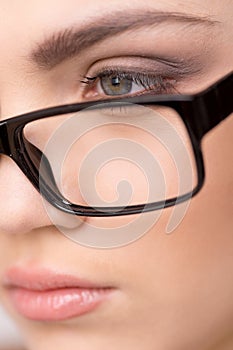 Beautiful young woman wearing glasses close-up.