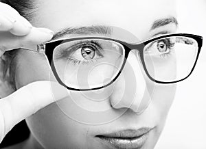 Beautiful young woman wearing glasses close-up isolated on white background.