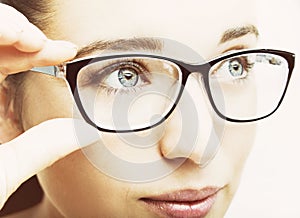 Beautiful young woman wearing glasses close-up isolated on white background.