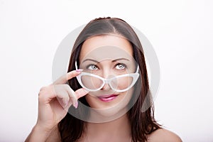 Beautiful young woman wearing glasses close-up isolated on white background