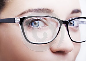 Beautiful young woman wearing glasses close-up isolated on white background.