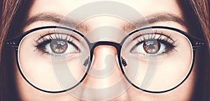 Beautiful young woman wearing glasses. Close up shot.