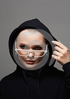 beautiful young woman wearing Hoodie and fashionable glasses