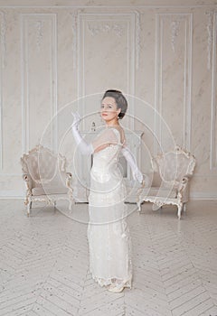 Beautiful young woman wearing medieval vintage Edwardian Style dress stand and turn