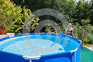 Beautiful young woman wearing one-piece swimsuit cleaning a fol