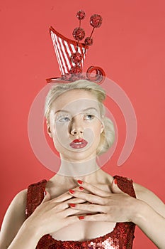 Beautiful young woman wearing red headgear over colored background