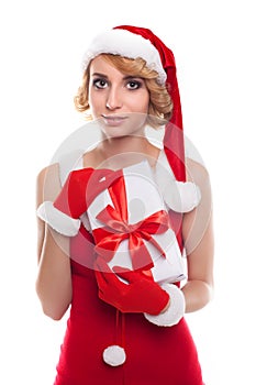 beautiful young woman wearing Santa Claus costume holding colorful gift boxes against white background