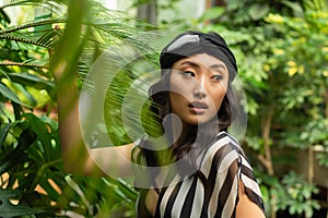 Beautiful young woman wearing summer clothes on tropical resort