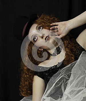 Beautiful young woman wearing top hat and crinoline