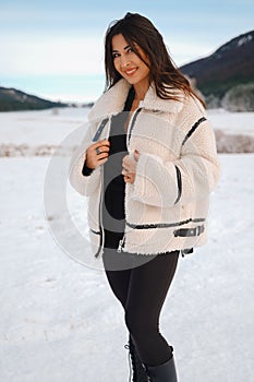 beautiful young woman wearing a winter jacket outdoors