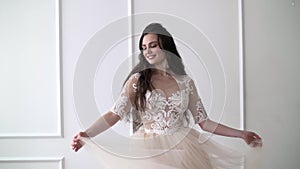 Beautiful young woman in a wedding dress whirls in dance