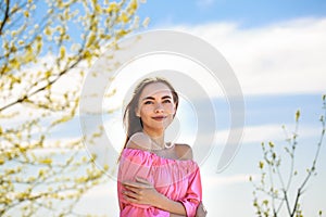 Beautiful young woman with a well-groomed face on a natural background