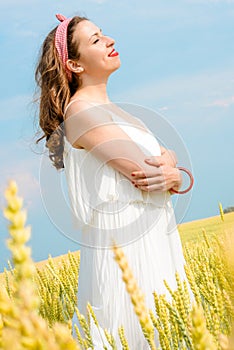 A beautiful young woman on a wheat field