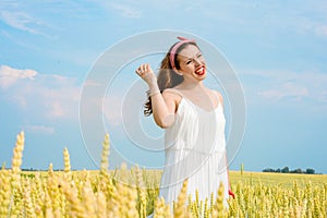 A beautiful young woman on a wheat field