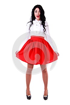 Beautiful young woman in a white blouse and a red skirt