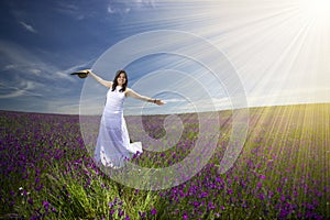 Beautiful young woman with white dress in field