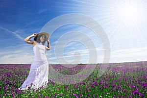 Beautiful young woman with white dress in field