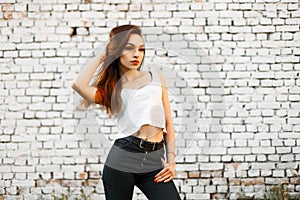 Beautiful young woman in a white T-shirt and black jeans
