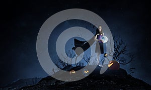 Beautiful young woman in witches hat and costume