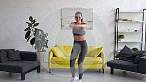 Beautiful young woman woman doing abdominal exercises in room