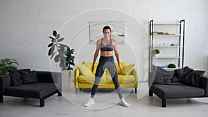 Beautiful young woman woman doing abdominal exercises in room