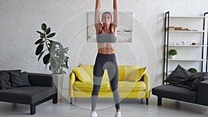 Beautiful young woman woman doing abdominal exercises in room